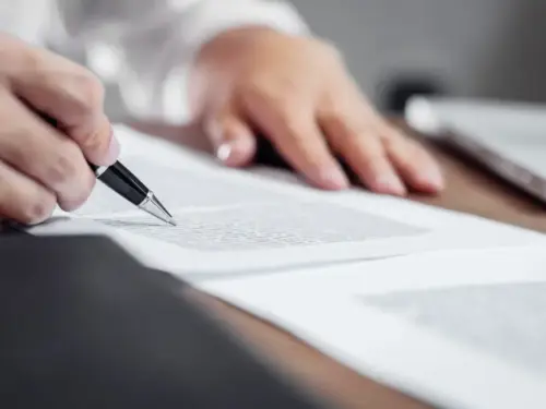 Agreement prepared by male lawyer signing contract.